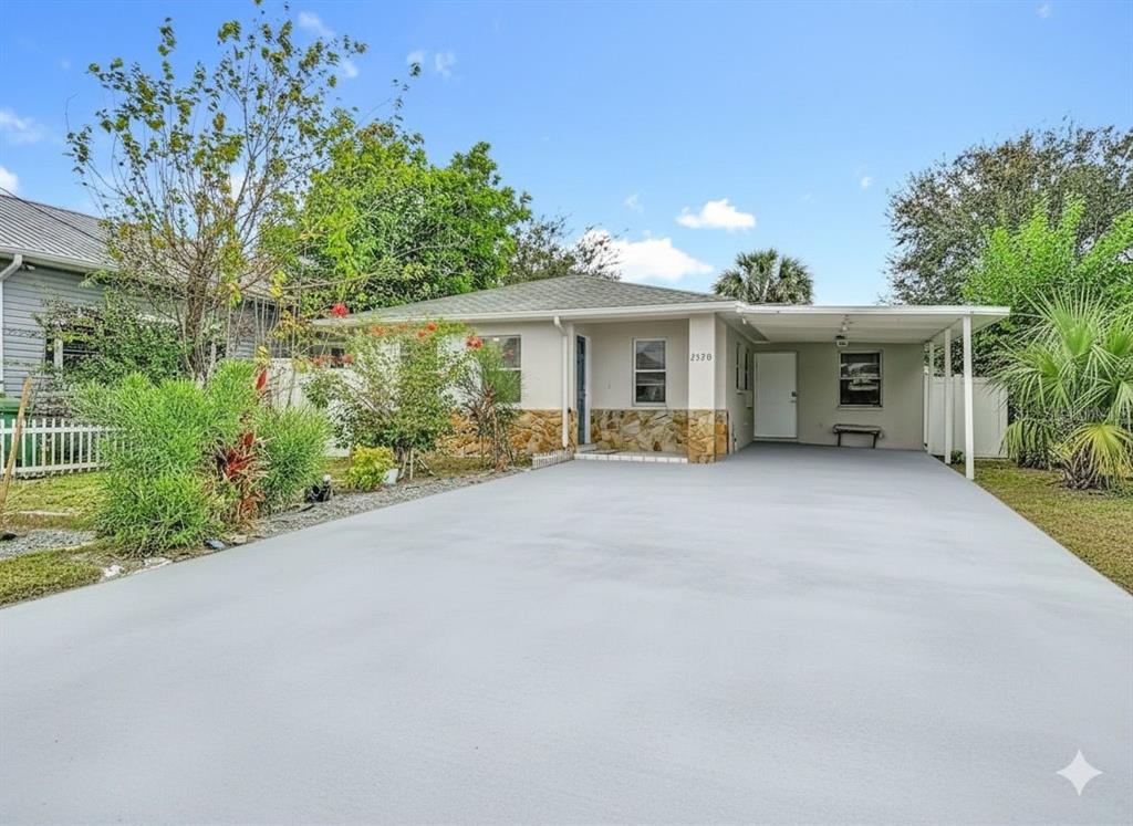 a view of house with outdoor space and garden