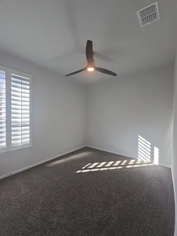a view of an empty room and window fan