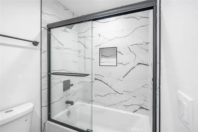 a bathroom with a toilet sink and a mirror