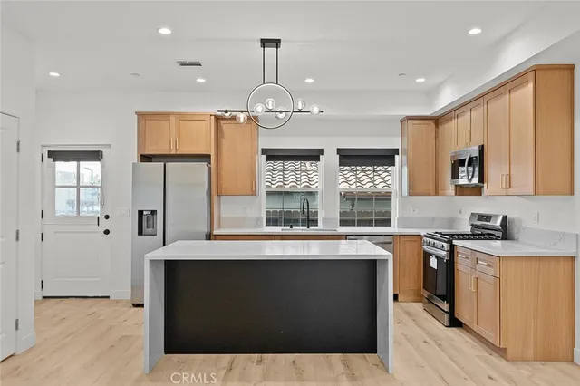 a kitchen with a sink stove and refrigerator