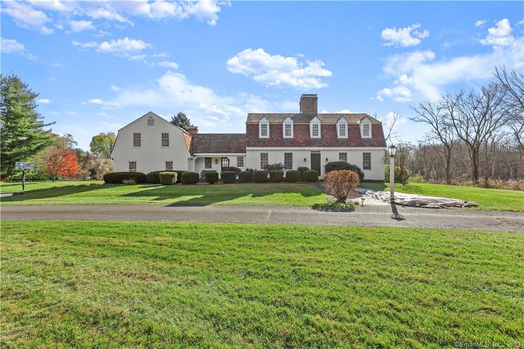46 Barlow Mountain Road Ridgefield, CT 06877 - Photo 1 of 1 a view of a house with a swimming pool and a yard