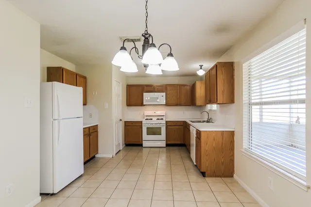 a kitchen with a stove sink and cabinets
