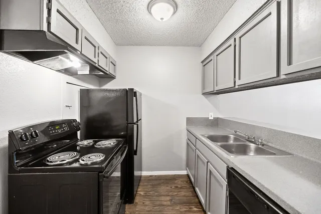 a kitchen that has a sink and a stove