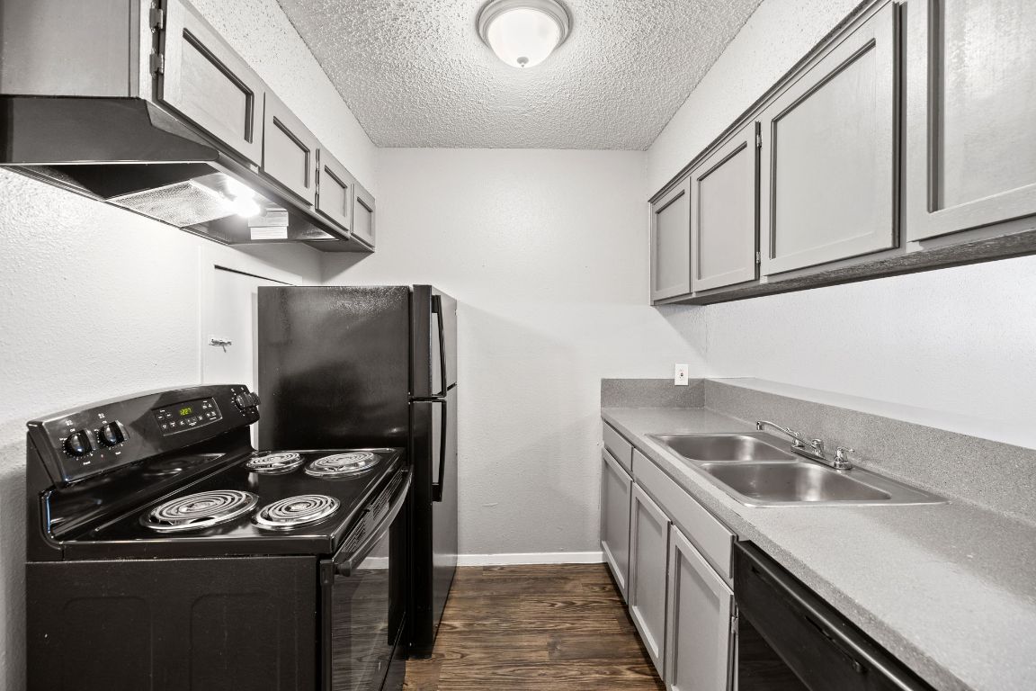 a kitchen that has a sink and a stove
