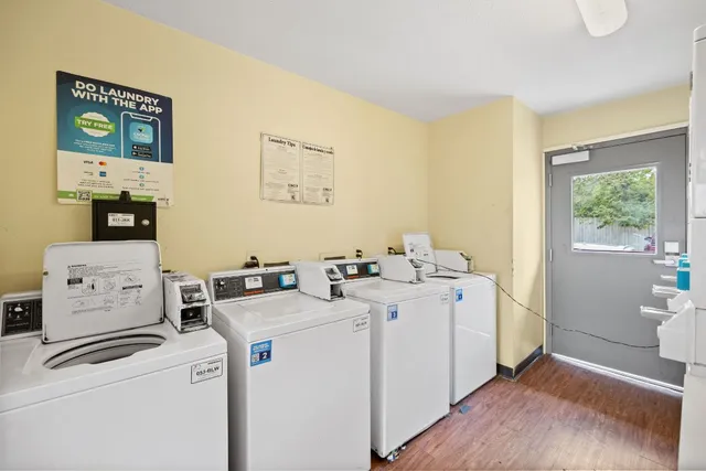 a utility room with cabinets washer and dryer