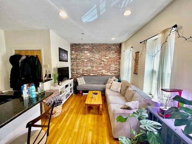 17 Thacher Street, Unit 3 Boston, MA 02113 - Photo 3 of 24 a living room with furniture and a flat screen tv