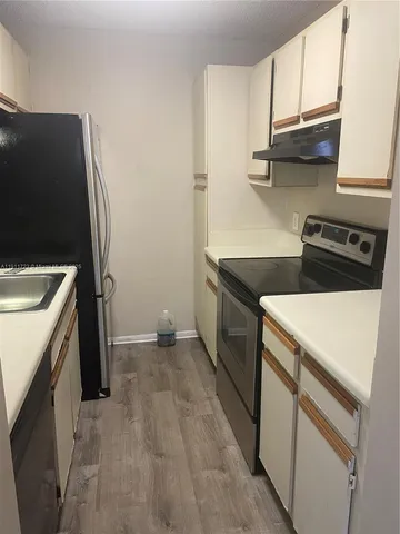 a kitchen with a stove and a refrigerator