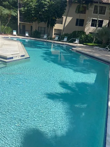 a swimming pool with outdoor seating and yard