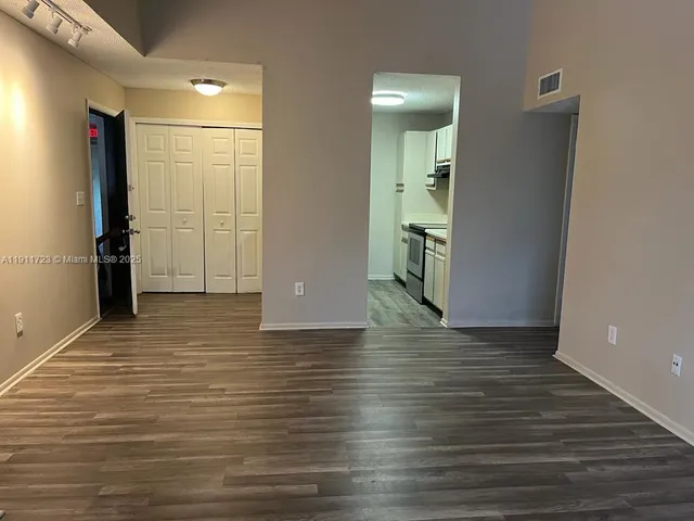 a view of a hallway with wooden floor