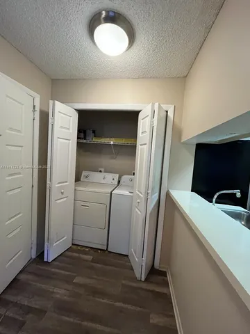 a kitchen with a sink a stove and a refrigerator