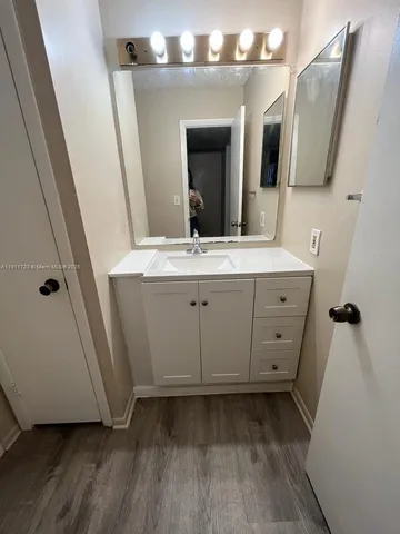 a white bath tub sitting next to a white toilet and a shower