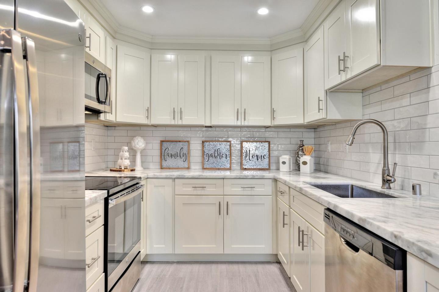 301 Kenbrook Circle San Jose, CA 95111 - Photo 7 of 19 a kitchen with stainless steel appliances granite countertop a sink stove and cabinets