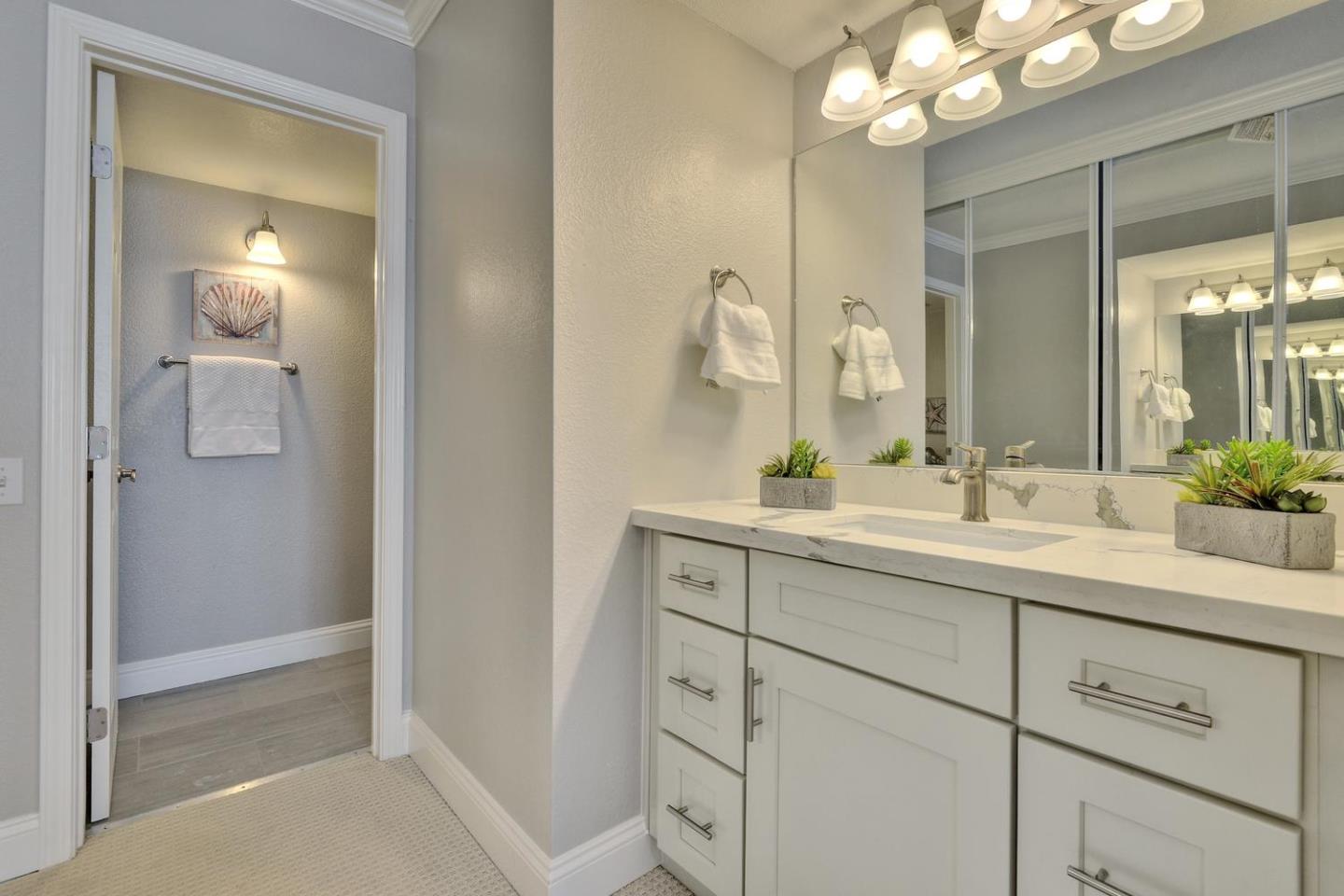 301 Kenbrook Circle San Jose, CA 95111 - Photo 10 of 19 a bathroom with a sink vanity and a mirror