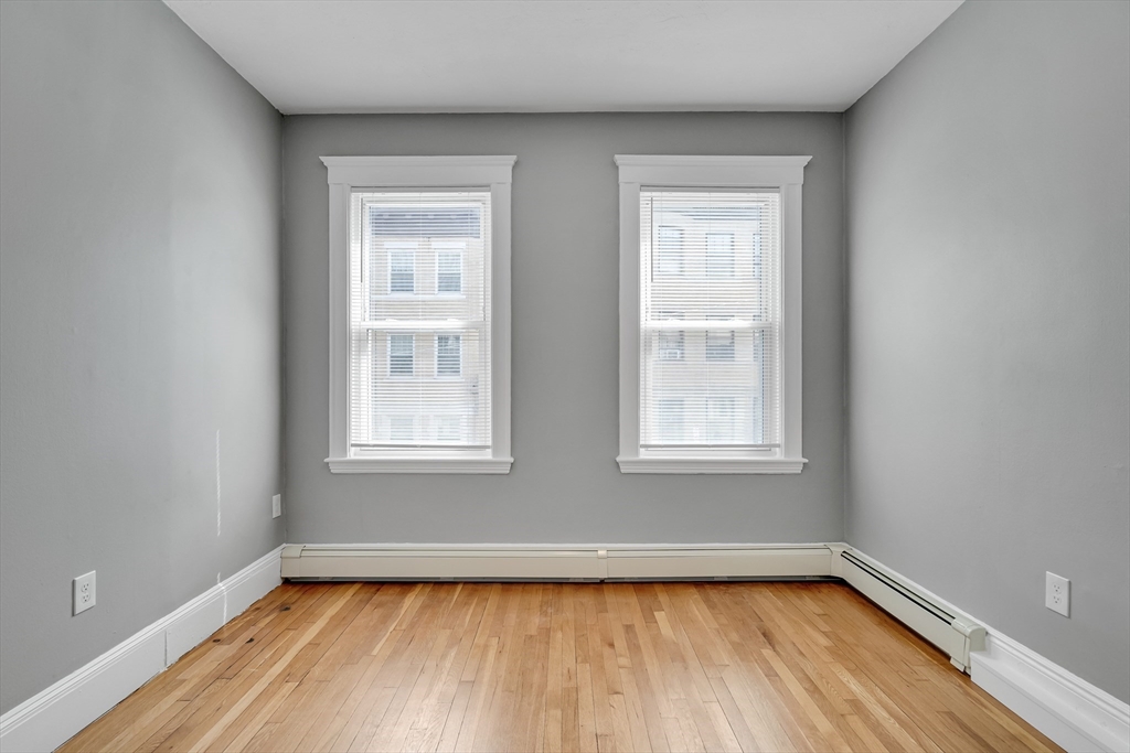 142 Sutherland Road, Unit 1 Boston, MA 02135 - Photo 11 of 16 a view of a room with window and wooden floor