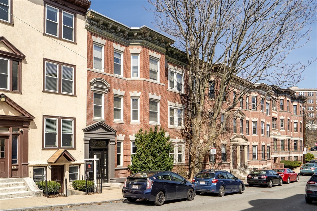 142 Sutherland Road, Unit 1 Boston, MA 02135 - Photo 15 of 16 a couple of cars parked in front of brick building