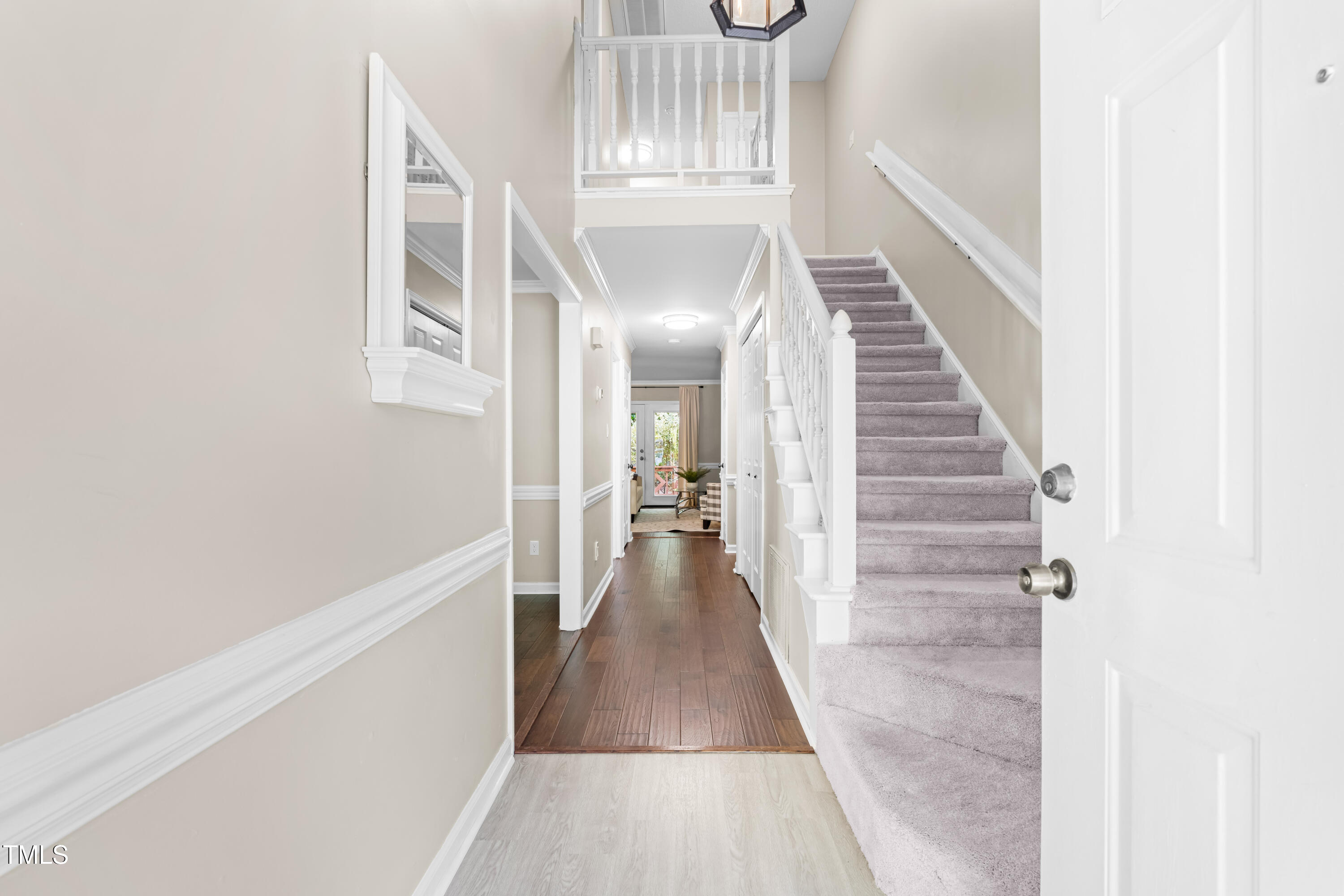 6104 New Market Way Raleigh, NC 27609 - Photo 4 of 38 a view of a hallway with wooden floor and staircase