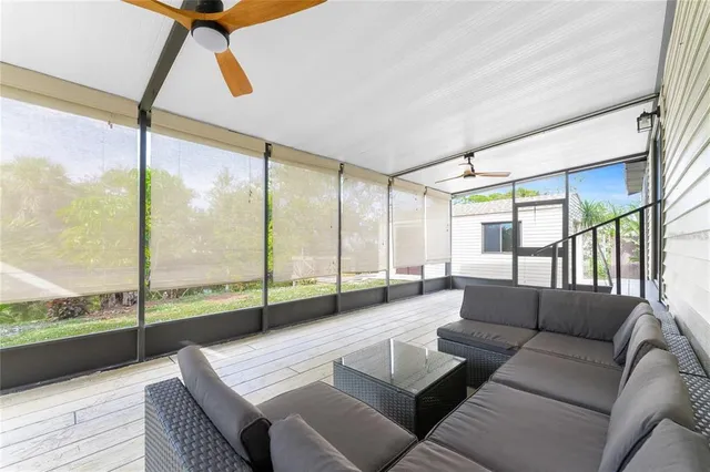 a living room with furniture and a floor to ceiling window