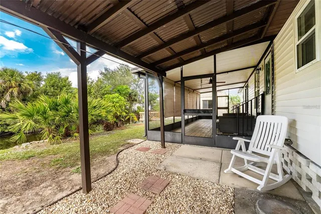 a view of a house with swimming pool and sitting area