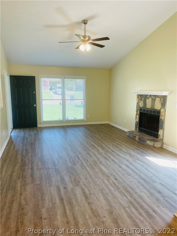 6501 Applewhite Road Fayetteville, NC 28304 - Photo 9 of 17 an empty room with wooden floor fan and windows