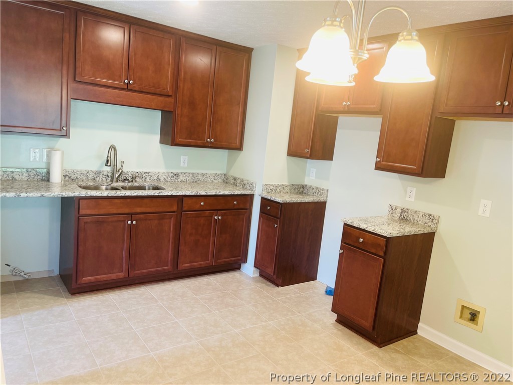 6501 Applewhite Road Fayetteville, NC 28304 - Photo 10 of 17 a kitchen with a refrigerator and a sink
