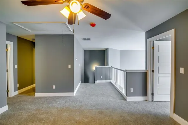 a view of a livingroom with a chandelier fan