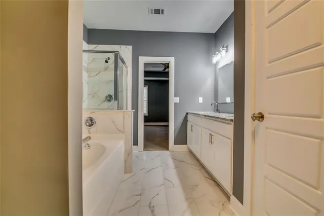 a bathroom with a double vanity sink and mirror