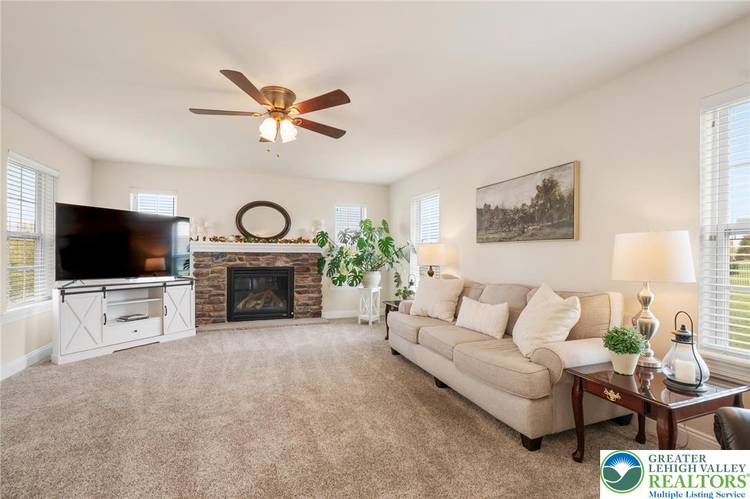 208 East Dell Road Bath, PA 18014 - Photo 16 of 40 a living room with furniture a fireplace and a flat screen tv
