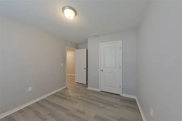 a view of an empty room and wooden floor
