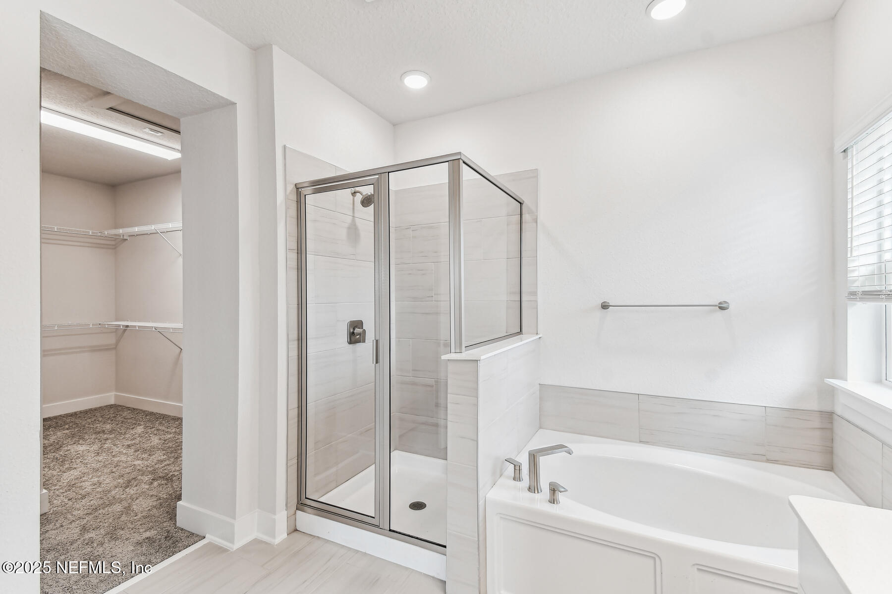 10085 Element Road Jacksonville, FL 32256 - Photo 20 of 24 a bathroom with a bathtub and a shower