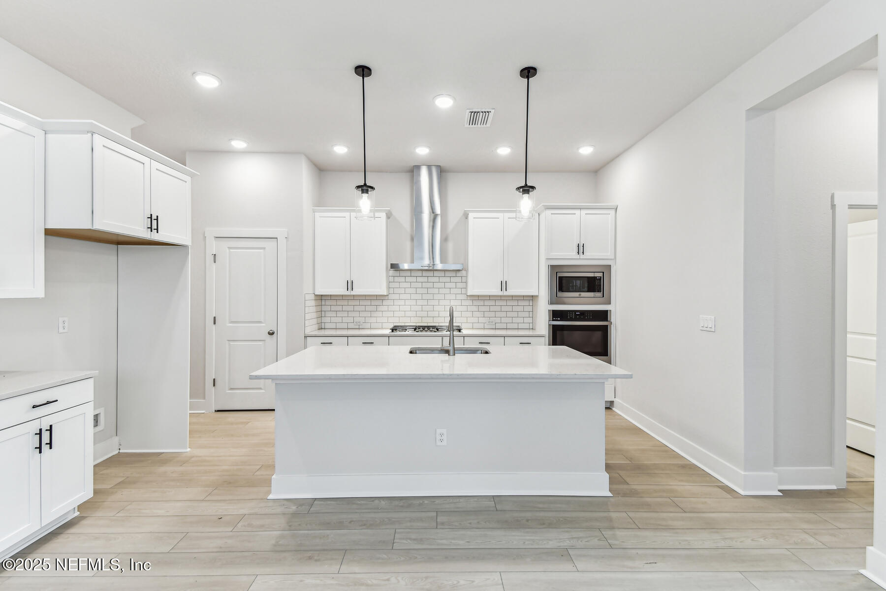 10085 Element Road Jacksonville, FL 32256 - Photo 2 of 24 a view of a kitchen with kitchen island a sink stainless steel appliances and cabinets
