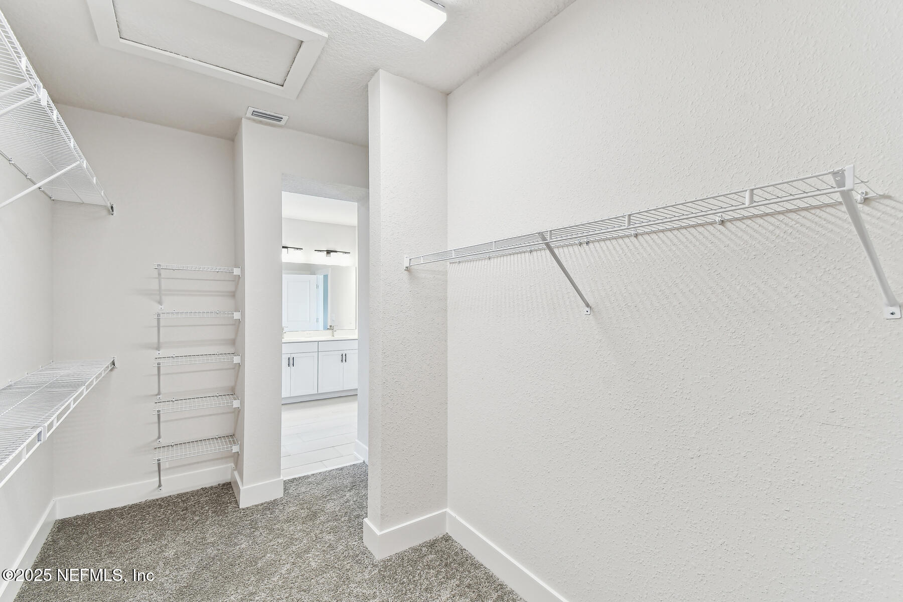10085 Element Road Jacksonville, FL 32256 - Photo 22 of 24 a view of walk in closet with empty racks