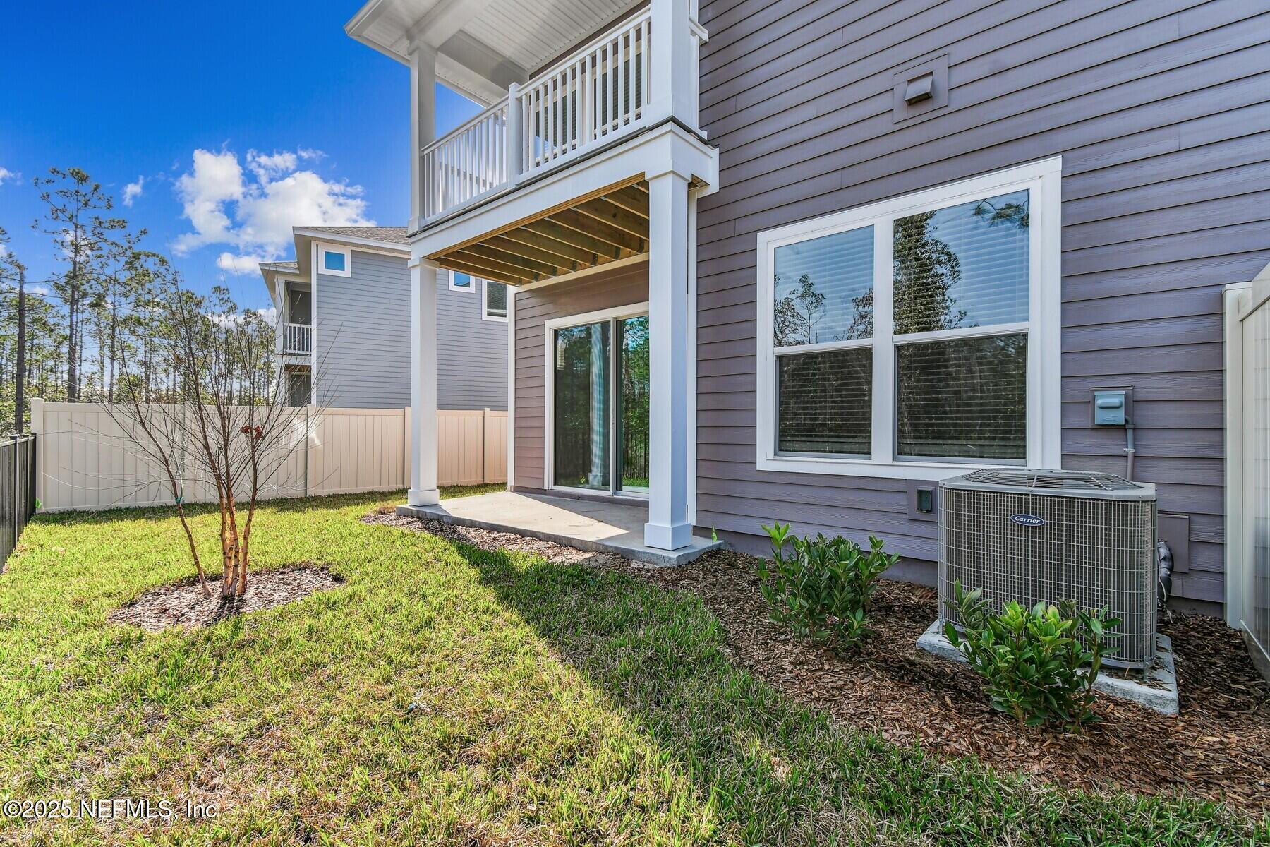 10085 Element Road Jacksonville, FL 32256 - Photo 24 of 24 a view of yellow house with a yard and table and chairs