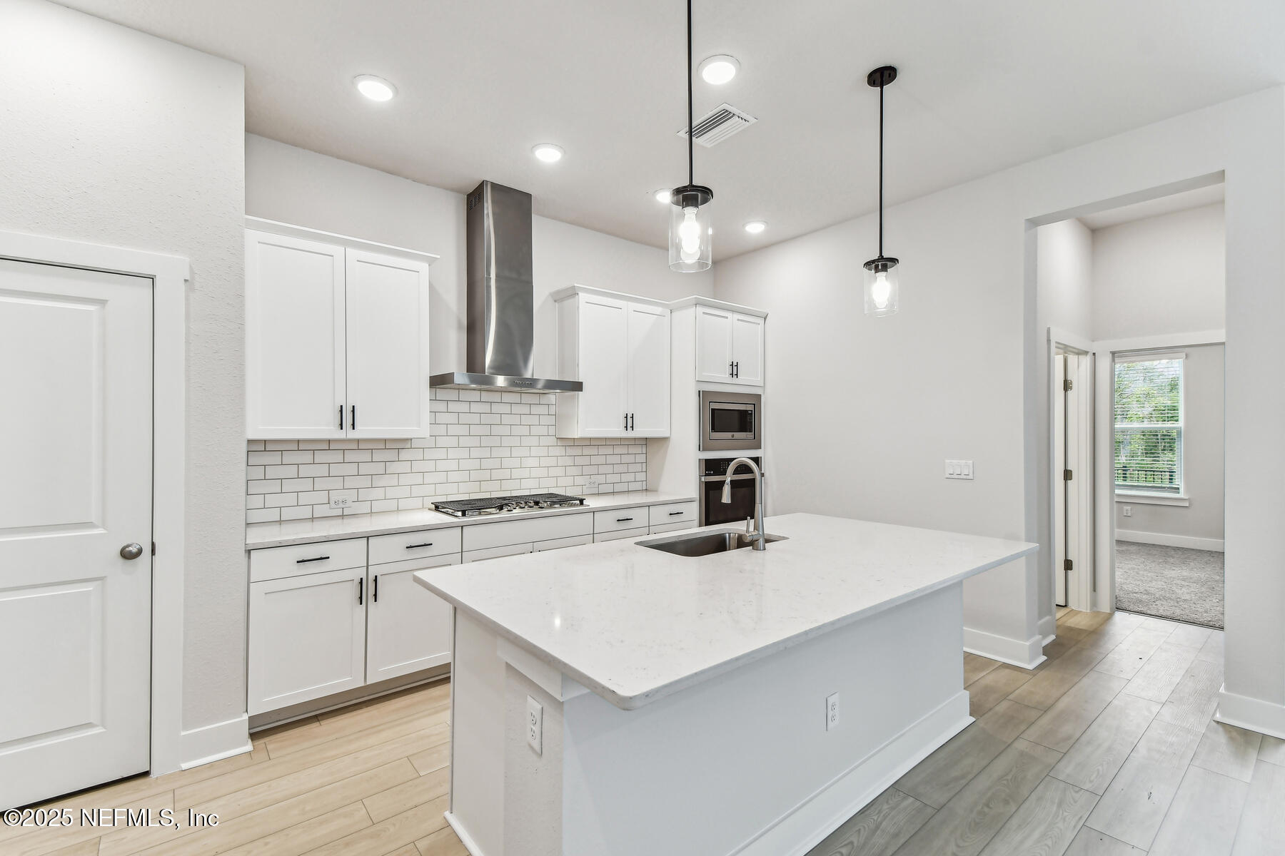 10085 Element Road Jacksonville, FL 32256 - Photo 6 of 24 a kitchen that has a lot of cabinets and wooden floor