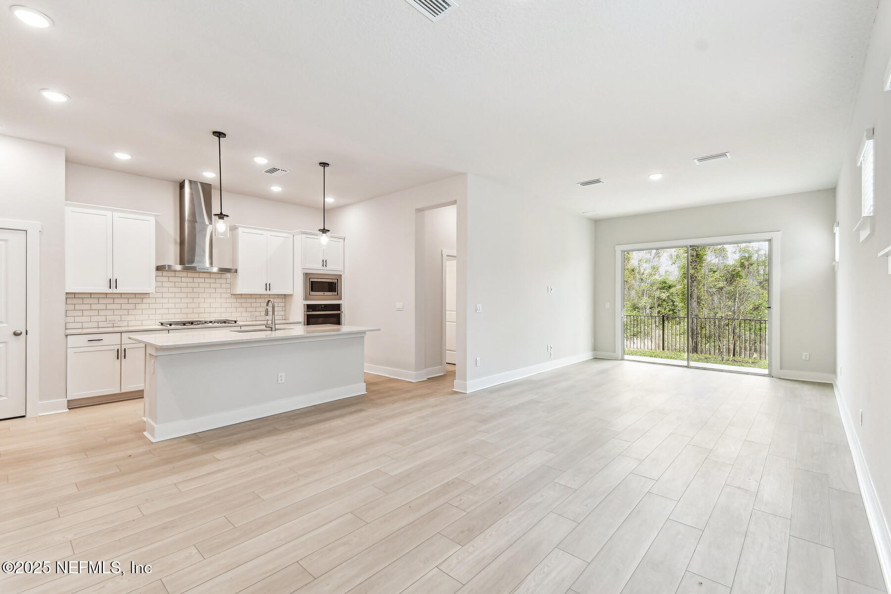 10085 Element Road Jacksonville, FL 32256 - Photo 7 of 24 a view of large kitchen with wooden floor and windows