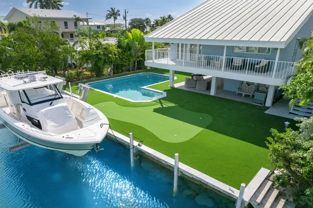 a view of a house with a backyard porch and sitting area