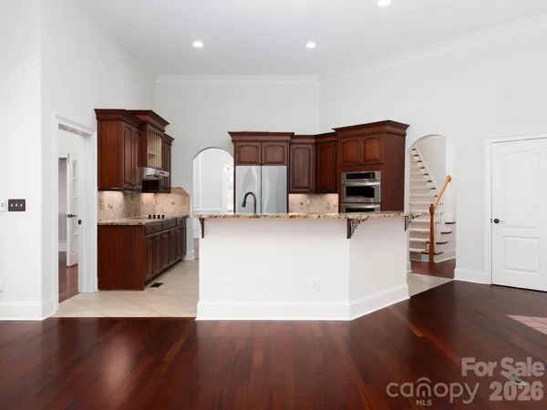 a large bathroom with a granite countertop sink a large mirror and a shower