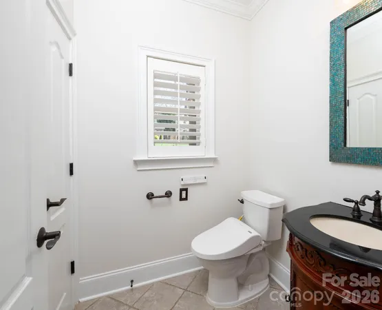 a bathroom with a granite countertop sink toilet a mirror and shower