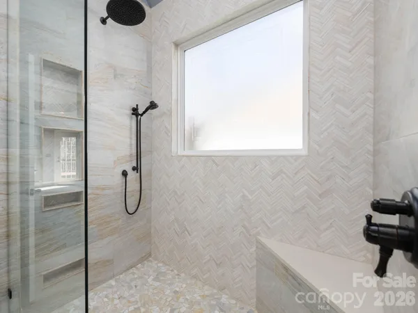 a front view of a house with a big yard and large trees