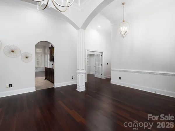 a view of empty room with wooden floor and window