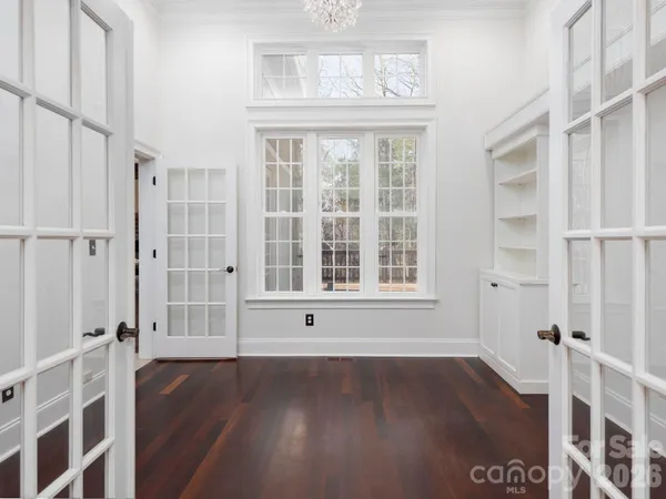 a view of empty room with wooden floor and fireplace