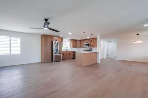 a view of a kitchen with a sink and a refrigerator