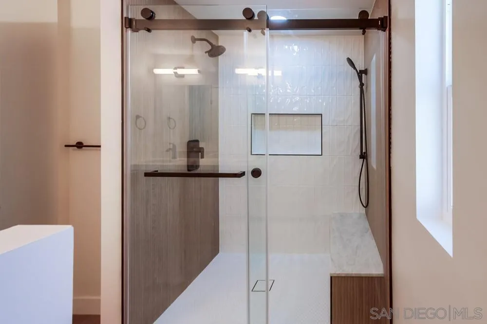 650 South Rancho Santa Fe Road, Unit 328 San Marcos, CA 92078 - Photo 19 of 22 a bathroom with a glass shower door and a sink