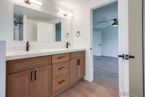 a bathroom with a double vanity sink and mirror