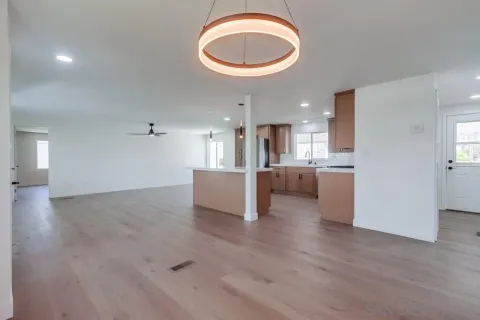 a view of a kitchen with a sink and a refrigerator