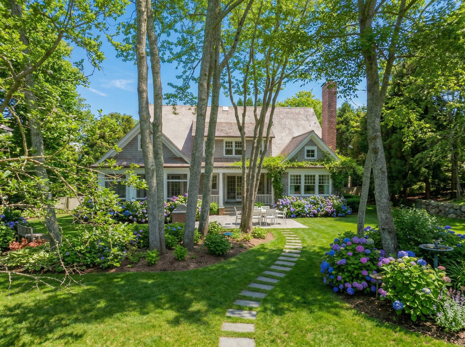 a view of a house with garden and trees