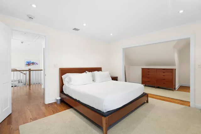 a bedroom with a bed and a table