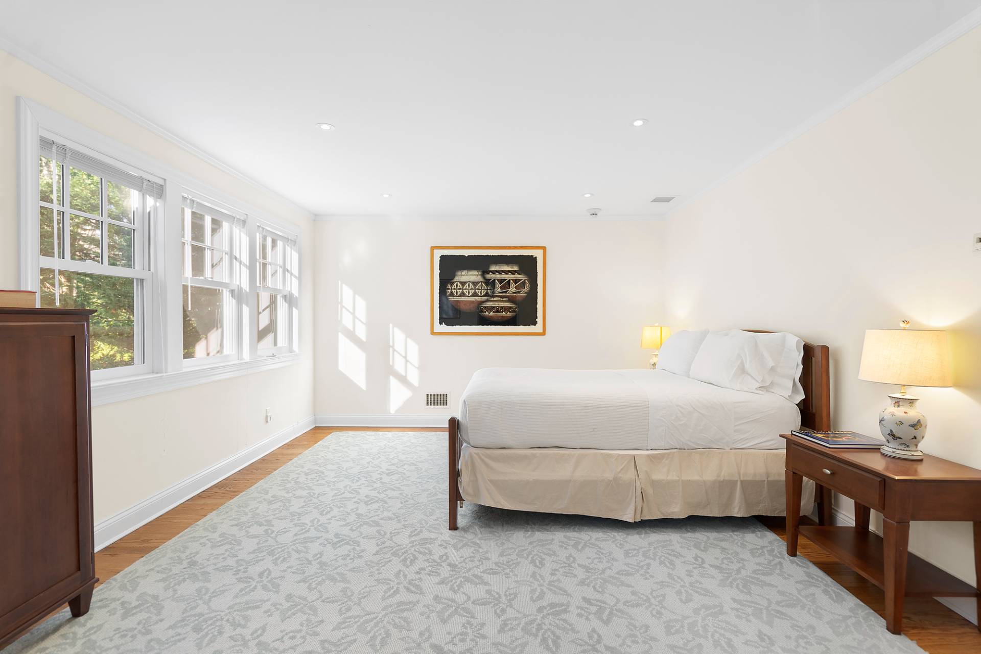 81 Georgica Road East Hampton, NY 11937 - Photo 12 of 15 a bedroom with a bed lamp and a window