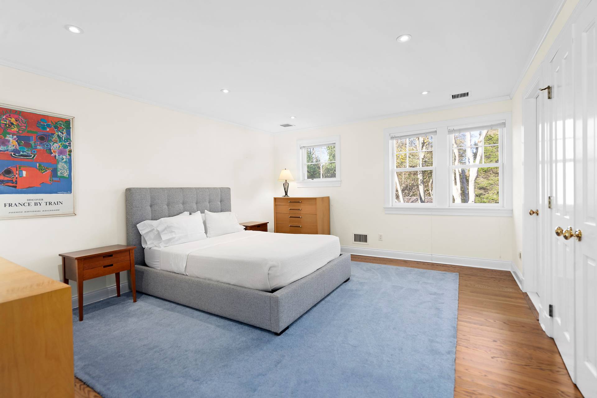 81 Georgica Road East Hampton, NY 11937 - Photo 13 of 15 a spacious bedroom with a bed and a couch