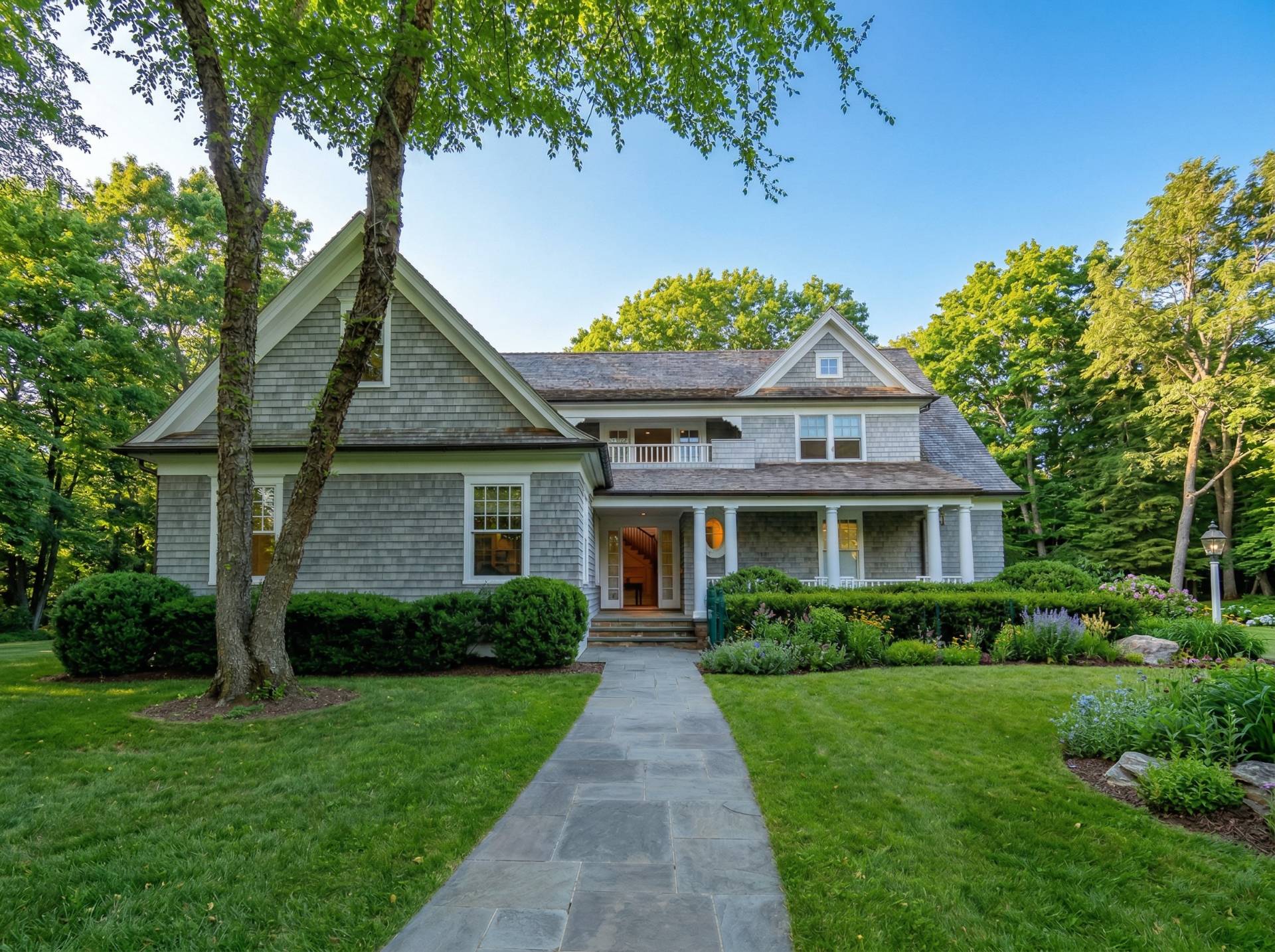 81 Georgica Road East Hampton, NY 11937 - Photo 2 of 15 a front view of a house with a garden