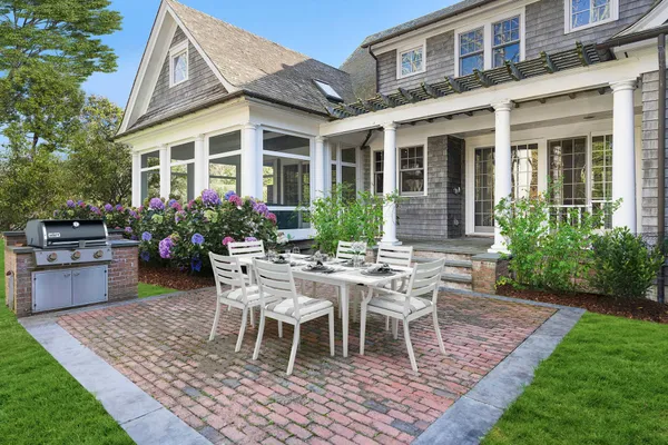a view of a house with backyard sitting area and garden